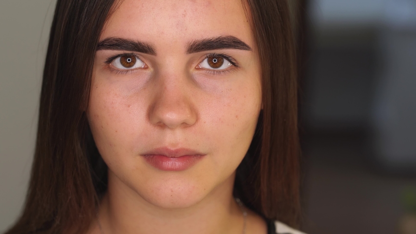 Closeup view 4k video portrait of young teenage pretty girl looking at camera. Result of modern trendy professional eyebrow tinting procedure. | Shutterstock HD Video #1060057310