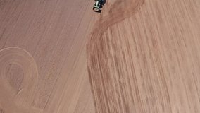 tractor plows field from above filmed in 4k