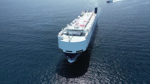 Aerial drone video of huge car carrier ship RO-RO (Roll on Roll off) cruising in Mediterranean deep blue Aegean sea