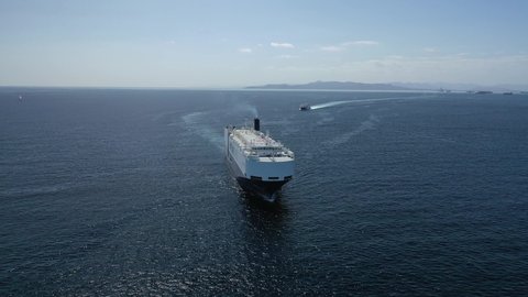 Aerial drone video of huge car carrier ship RO-RO (Roll on Roll off) cruising in Mediterranean deep blue Aegean sea