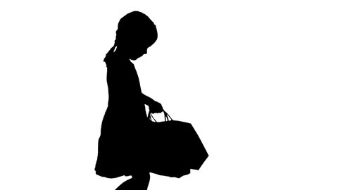 Silhouette Beautiful little girl in black dress walking with shopping bags.