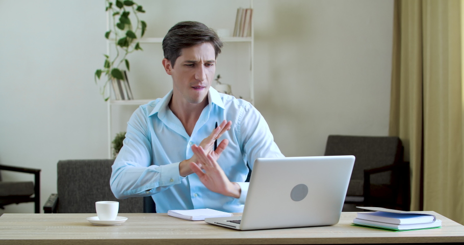Portrait of happy businessman sitting in office or at home at table, working at laptop online, reading positive news, celebrating, dancing with joy, actively moving his hands, drinking aromatic coffee | Shutterstock HD Video #1060073960