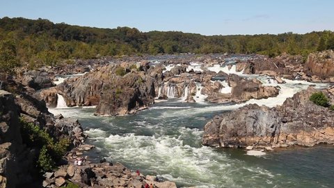 Closeup view of the cascading water at great falls region of the potomac river. footage was taken from a scenic overlook at Great Falls park in virginia. Water sparkles as it moves fast through rocks.