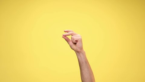 one arm snapping fingers on yellow background