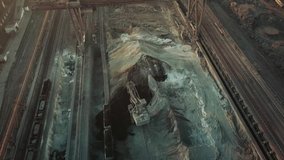 Industry manufacturing excavator loading a train aerial video 4K.