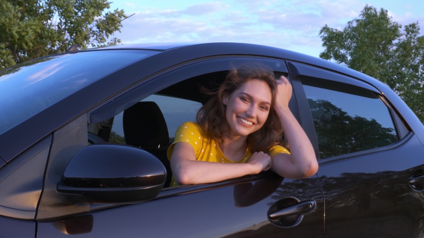 Happy woman with key sitting in new car | Shutterstock HD Video #1060083452