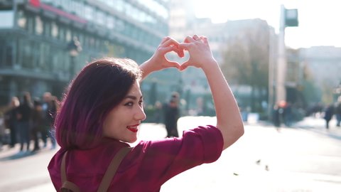 Woman Made Love Heart From Fingers. Woman Enjoying Sun light. Lady Making Heart Shape With Hands. Sun Rays On Morning Weekend. Vacation Holidays Time.Love Hearth Signs Symbols