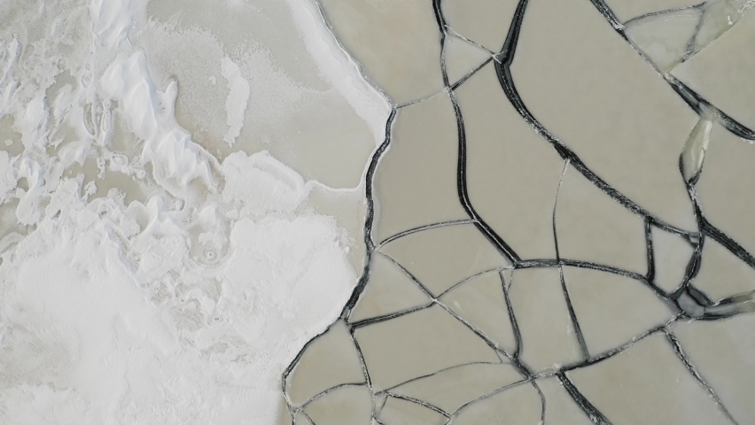 Thick sheets of ice over surface of lake