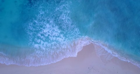 Big white waves of azure sea foaming over pink sand of exotic beach in Bermuda, beautiful sea texture, copy space