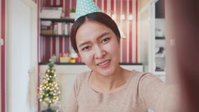 POV Asian woman holding wine glass and countdown to celebrate a party via video call conference, new normal for birthday Christmas and new year party at home