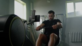 Sportsman Do Hard Exercises With Rowing Machine . - Powered by Shutterstock - Get 15% off with code: PIKWIZARD15