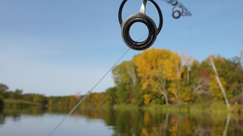 fishing line passes through the rings on a spinning rod, trolling fishing from a boat, close-up, first-person view