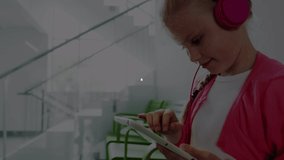 Animation of digital icons with network of connections over woman with headphones using digital tablet. Global online network digital interface concept digitally generated image. - Powered by Shutterstock - Get 15% off with code: PIKWIZARD15