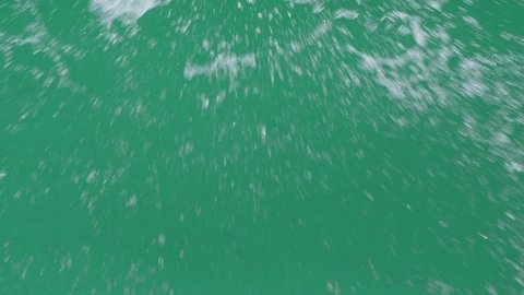 Slow motion of abstract water splashing over green screen chroma key background