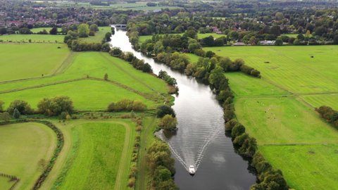 4k aerial a boat on The River Thames towards Pangbourne, Berkshire, UK