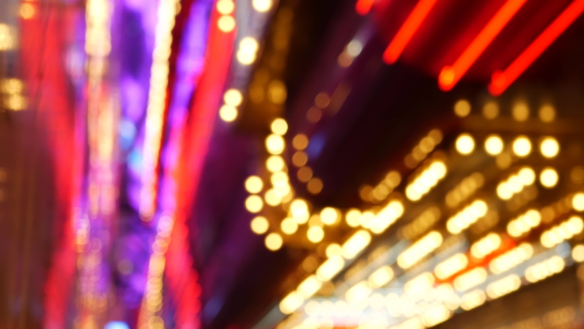 Defocused old fasioned electric lamps glowing at night. Abstract close up of blurred retro casino decoration shimmering, Las Vegas USA. Illuminated vintage style bulbs glittering on Freemont street.