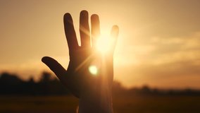 girl stretches out her hand in the sun. faith in god dream a religion concept. hand in the sun close-up silhouette sunlight dream of happiness - Powered by Shutterstock - Get 15% off with code: PIKWIZARD15