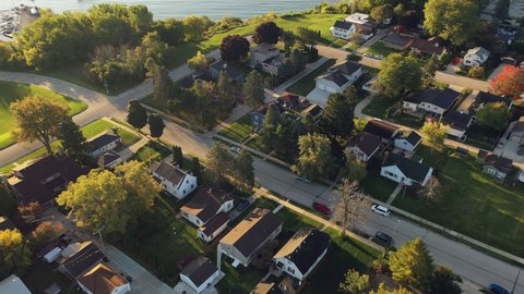 Aerial drone view of suburban neighborhood on the shoreline of Lake Michigan. Establishing shot of American suburb. Residential houses in Milwaukee, Wisconsin