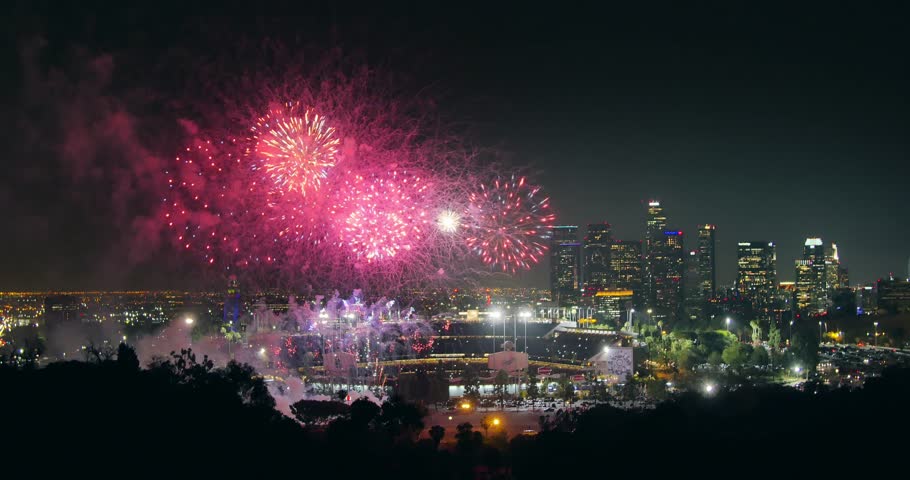 Fireworks display over city of Los Angeles downtown skyline at night. 4K UHD.