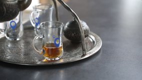 Pouring hot tea into turkish tea glass