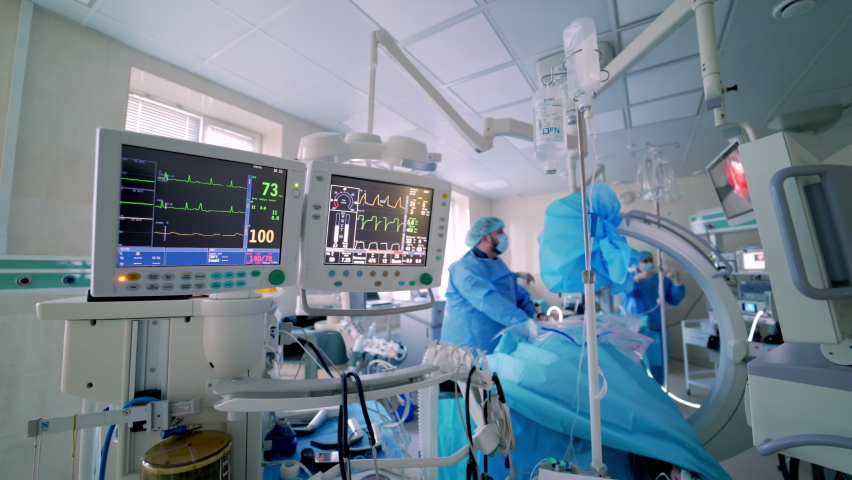 Medical monitors on surgery background. Medical vital signs of a patient on monitor. Anesthesia surgery monitor. Patient's heartbeat on the screen in hospital theater. Royalty-Free Stock Footage #1060113131