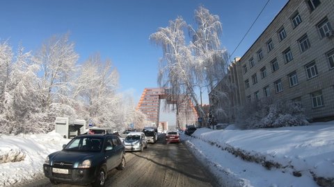 NOVOSIBIRSK, RUSSIA - FEBRUARY 12, 2020: Novosibirsk Academgorodok in winter. Driving on a snowy Nikolaev street in technopark.
