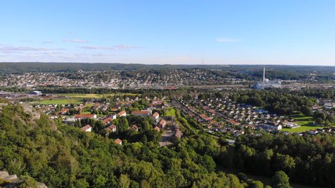 Suburb Swedish area east of Gothenburg, scenic aerial drone view above forest hill, Sweden, forward, day