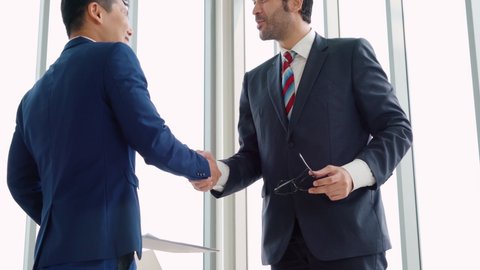 Business people handshake with friend at office showing trust , friendship and success celebration .