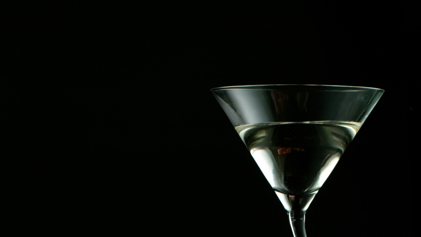 Super Slow motion shot of olives splashing into Dry Martini Drink Royalty-Free Stock Footage #1060136354
