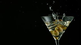 Super Slow motion shot of olives splashing into Dry Martini Drink - Powered by Shutterstock - Get 15% off with code: PIKWIZARD15