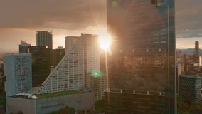 Cinematic view on sunset light and golden clouds over the modern business area in Mexico city. 4K aerial of glass buildings architecture with latin cityscape on motion background. Business offices - Powered by Shutterstock - Get 15% off with code: PIKWIZARD15