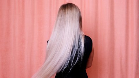 Hair. Beautiful healthy long straight blonde hair close-up. Dyed white blond hair background, coloring, extensions, cure, treatment concept. Haircare. Slow motion 4K UHD video.