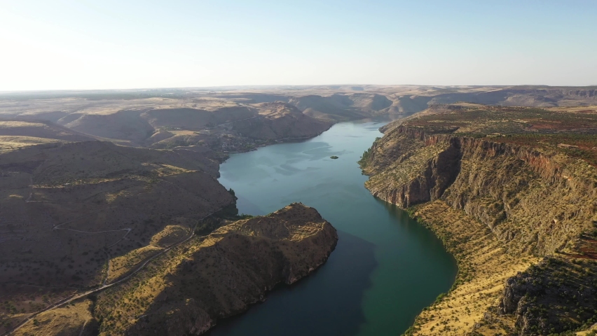 Halfeti is a small farming district on the east bank of the river Euphrates in Şanlıurfa Province in Turkey, 120 km from the city of Şanlıurfa.	 Royalty-Free Stock Footage #1060143776