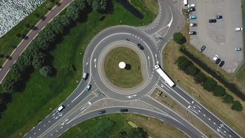 Drone shot from roundabout with traffic in the Netherlands. Traffic jam solution. Better traffic flow. Full HD Footage.