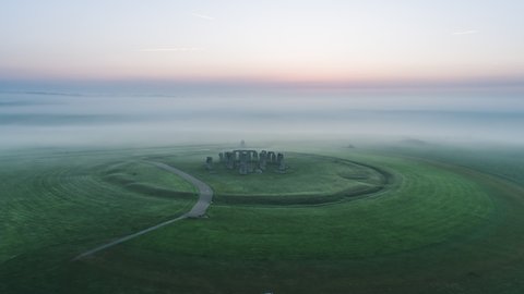 Aerial view shot of Stonehenge, Prehistoric Monument, Wiltshire, United Kingdom, stunning foggy morning