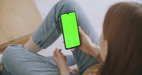 Phone with Green Screen and Chroma Key Closeup. Chromakey Mockup with Tracking Markers and Alpha Matte. POV is Vertical Template of Device in Modern House Closeup. Scroll Up Online News at Cellphone