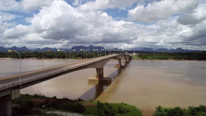 Thai–Lao Friendship Bridge over the Mekong River. Landscape of Mekong river in border of Thailand and Laos, Nongkhai province Thailand. Important Import Export Transportation bridge.
 Royalty-Free Stock Footage #1060161884