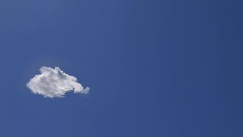 Fast Billowing Increasing Lone Cloud Isolated on Clear Soft Blue Sky, Time Lapse. Concept of Purity and Lightness
