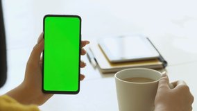 Handheld Camera: Point of View of Woman at Room Sitting on a Chair Using Phone With Green Mock-up Screen Chroma Key Surfing Internet Watching Content Videos Blogs