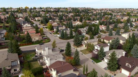 Aerial view of homes and streets in beautiful residential neighbourhood during fall season in Calgary, Alberta, Canada.