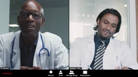 Middle Aged and Young Male Doctors Having Video Meeting