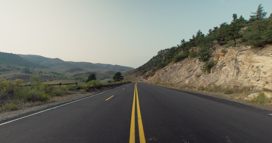 Cyclist riding down a road at Dinosaur Ridge in Colorado
