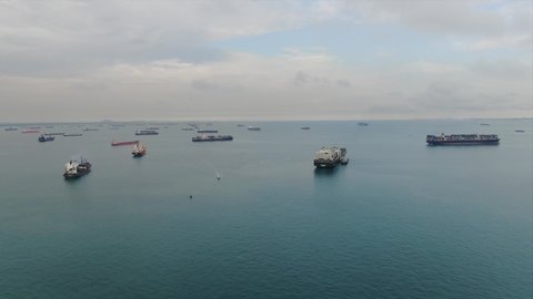 Ships are anchored in the port of Singapore. Ships stand by.
Hundreds of cargo ships anchored off the coast of Singapore.