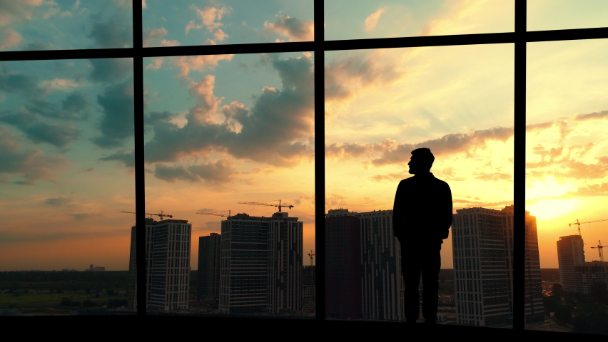 The man is standing in the office on the building background Royalty-Free Stock Footage #1060177163