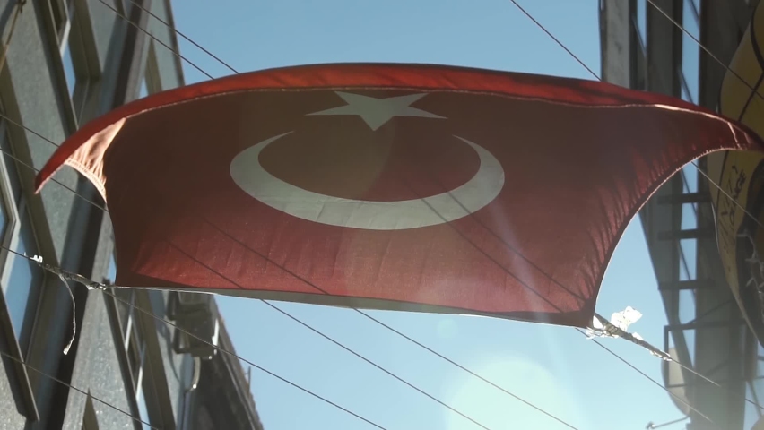 Turkish flag waving on a street of Istanbul against sunlight. National symbol of Turkey. Slow motion Royalty-Free Stock Footage #1060179596