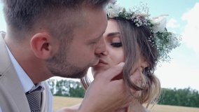 kiss of the newlyweds outdoors.young wedding couple outdoor