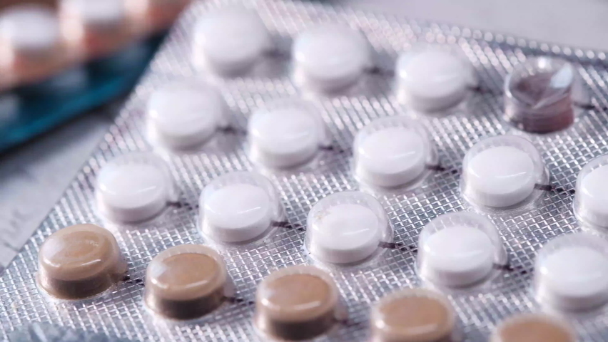 Birth control pills on wooden background, close up  | Shutterstock HD Video #1060185494