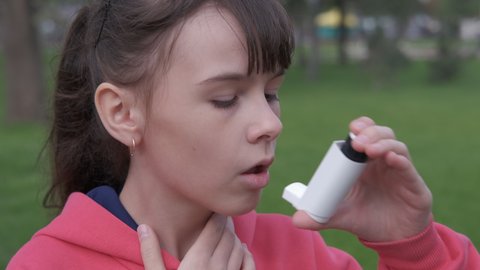 Asthmatic attack. Teenage girl is choking from asthma.