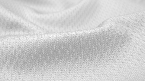 Close up detailed cloth texture of shiny spandex lycra cloth flowing with dolly shot in macro close-up view. Wavy clean elastic weave material. Textile abstract background. Clothing industry concept.