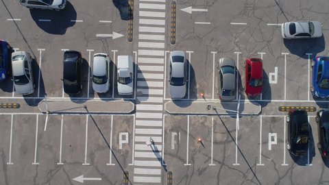 Parking near the store view from the drone. A lot of cars in the parking lot top view